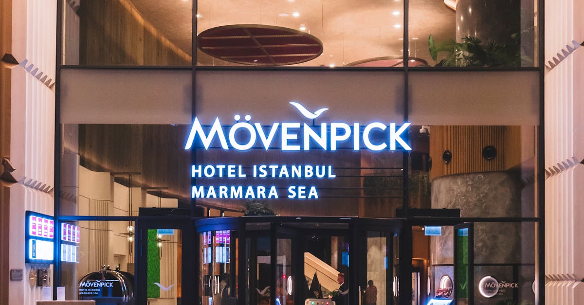 Night view of Mövenpick Hotel Istanbul Marmara Sea entrance with illuminated signage and glass facade.